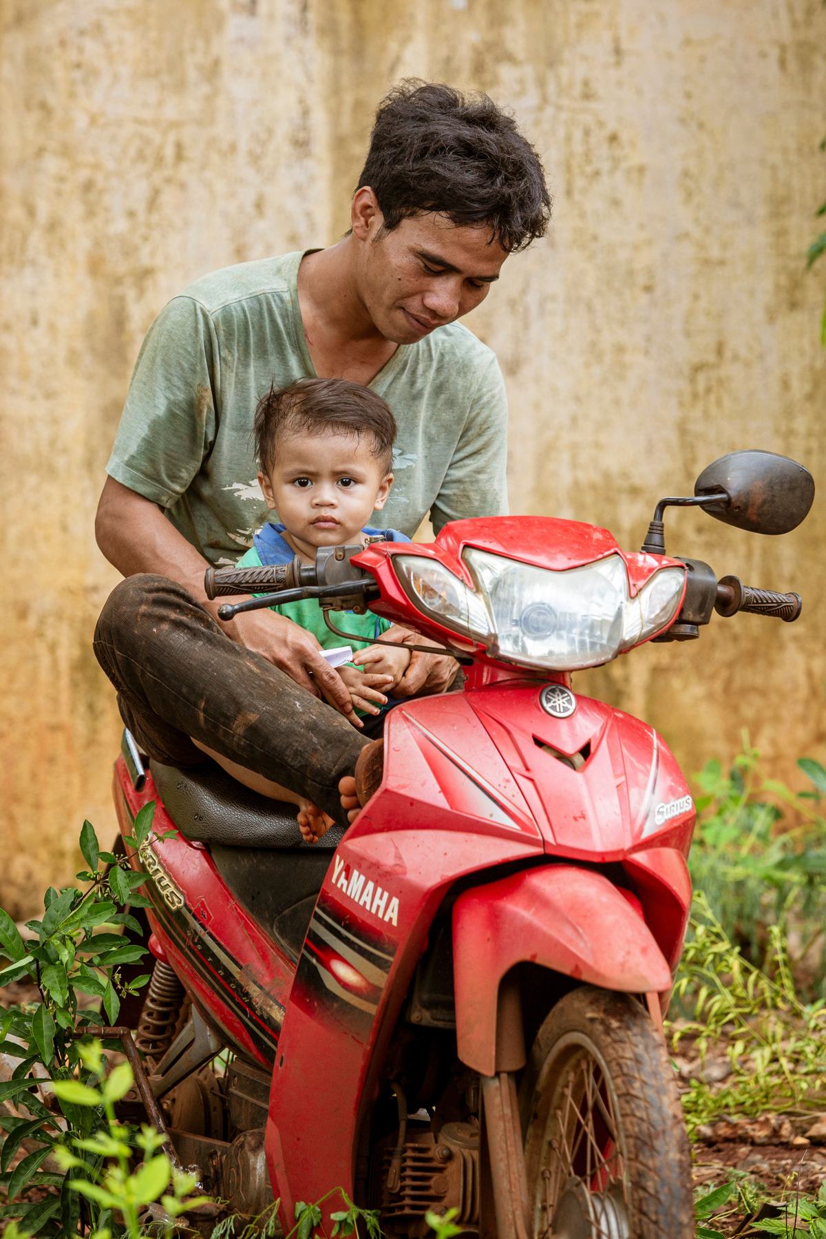A father holding his small child close